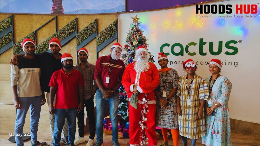Hoods Hub Team Celebrates the Holidays Hoods Hub team celebrates with a team Christmas party photo. Happy coworkers in festive attire enjoy a group photo with Santa